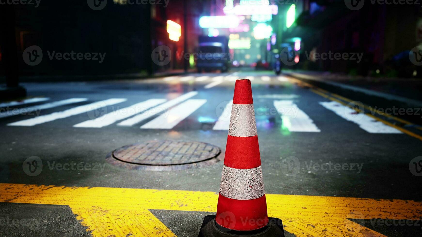 A red and white traffic cone sitting on the side of a road photo