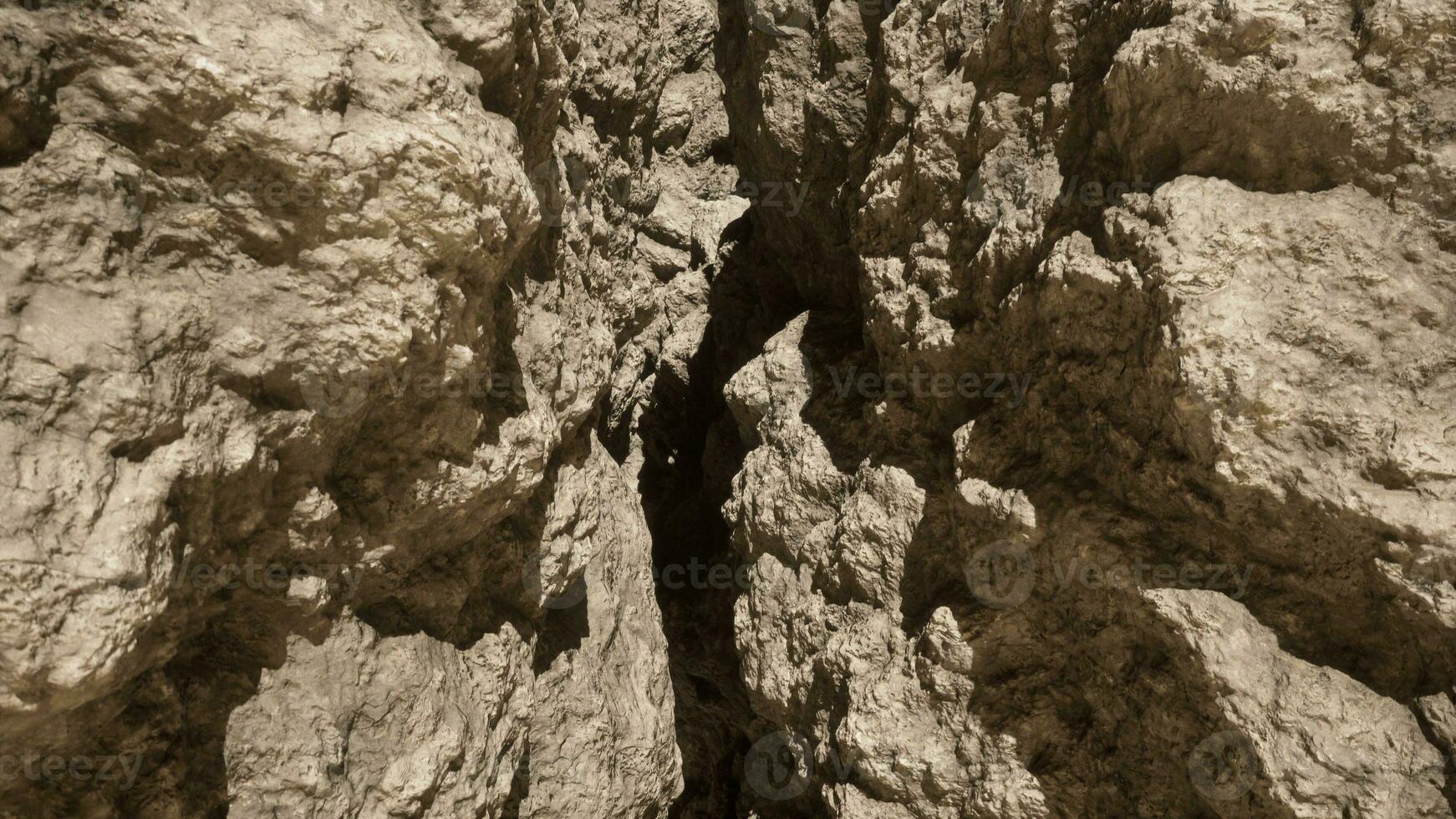 A very tall rock formation with a sky background photo