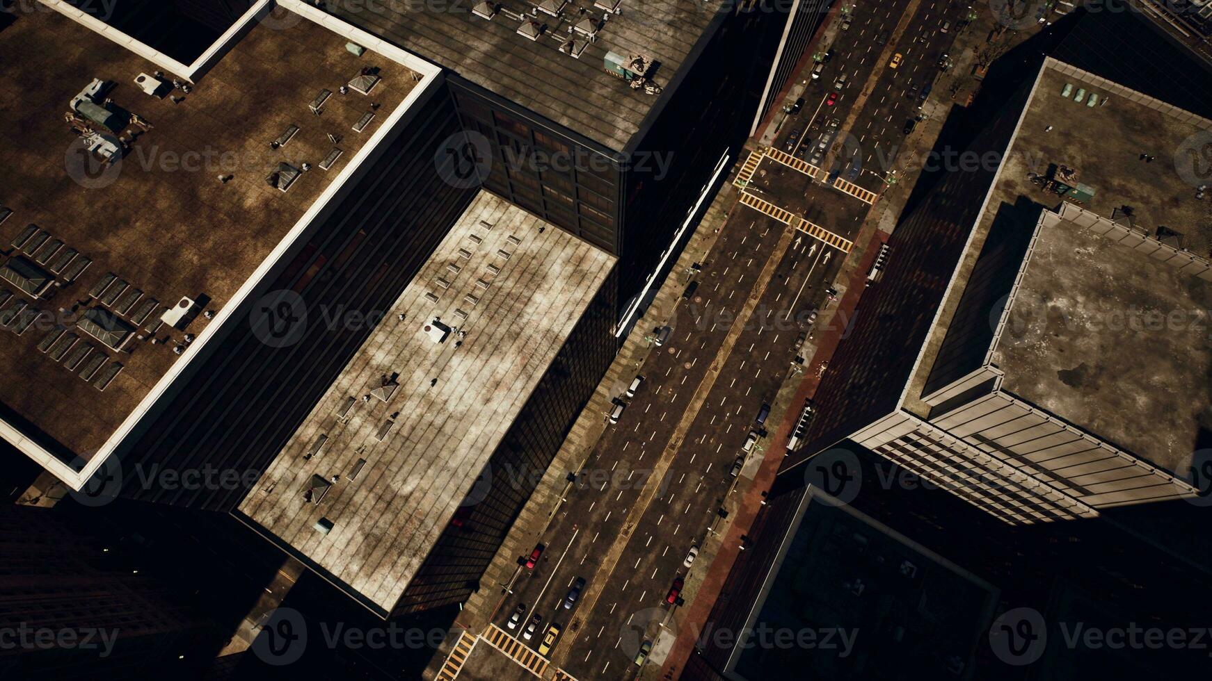 A bird's eye view of a bustling city street surrounded by towering buildings photo