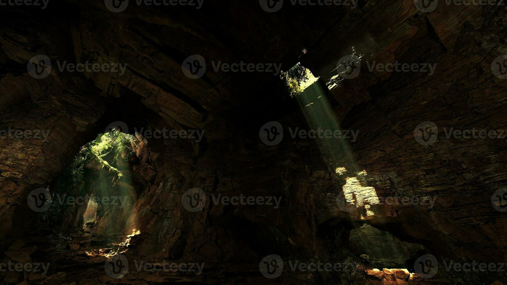 A cave illuminated by a mesmerizing volume of light shining through rocks photo