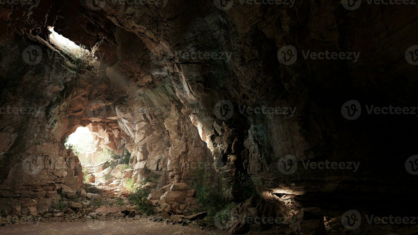 A mysterious cave illuminated by a beam of light photo