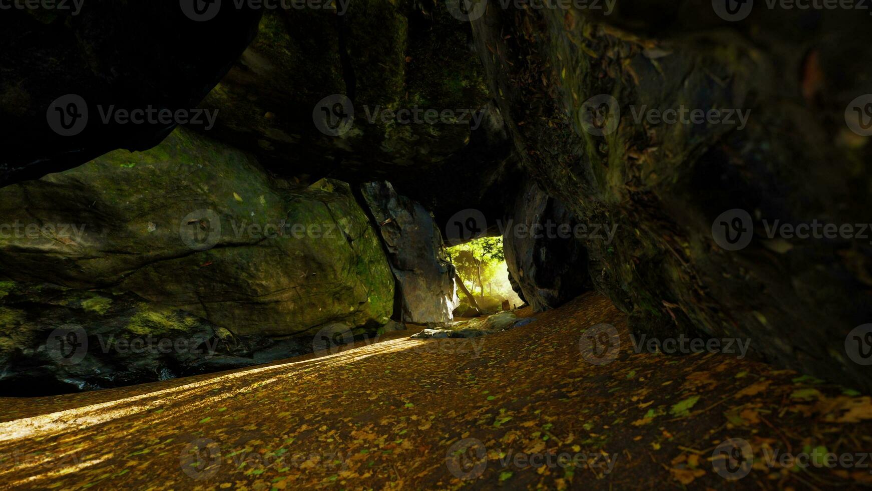 Empty road goes through the cave with glowing end photo