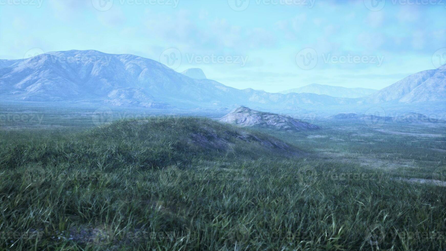 A scenic view of mountains in a beautiful grassy field photo
