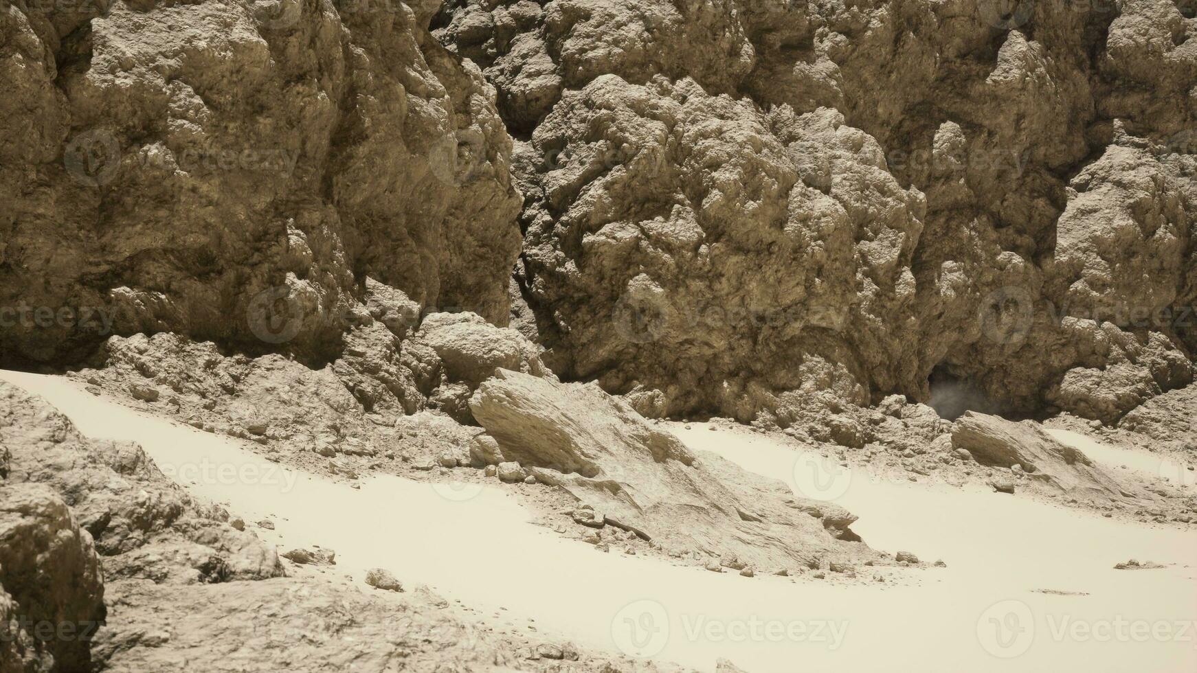 A group of rocks sitting on top of a sandy beach photo