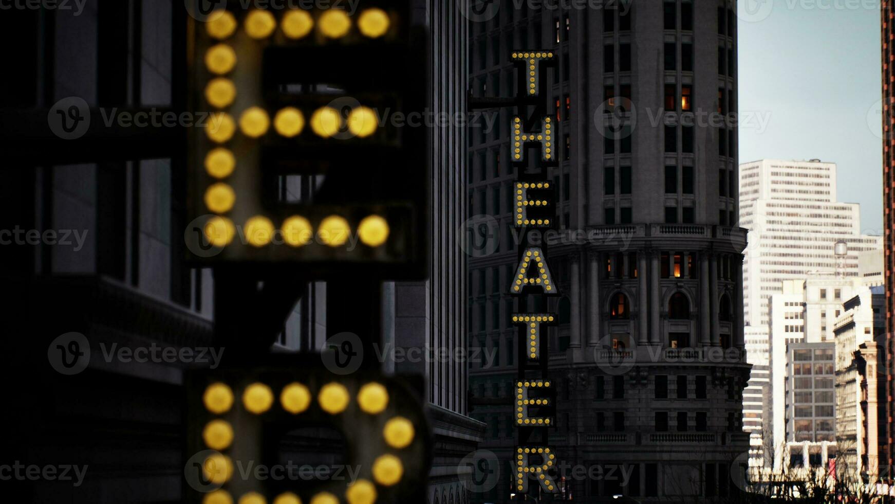 A bustling city street with a vibrant theater sign photo