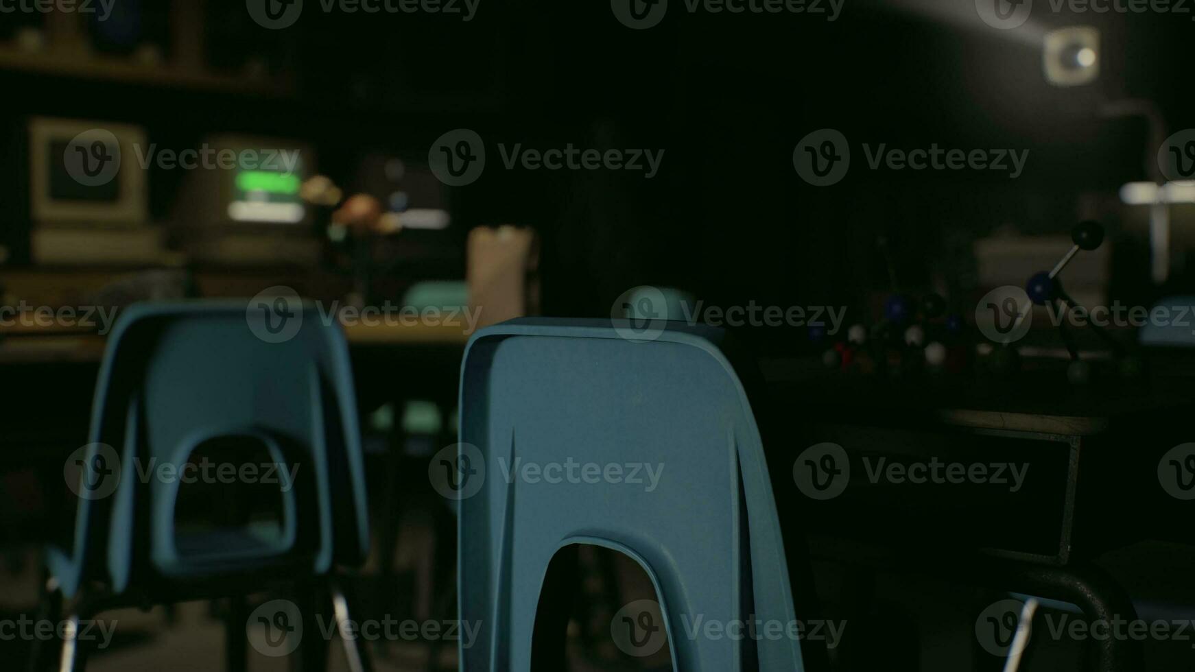 A couple of blue chairs sitting next to each other photo