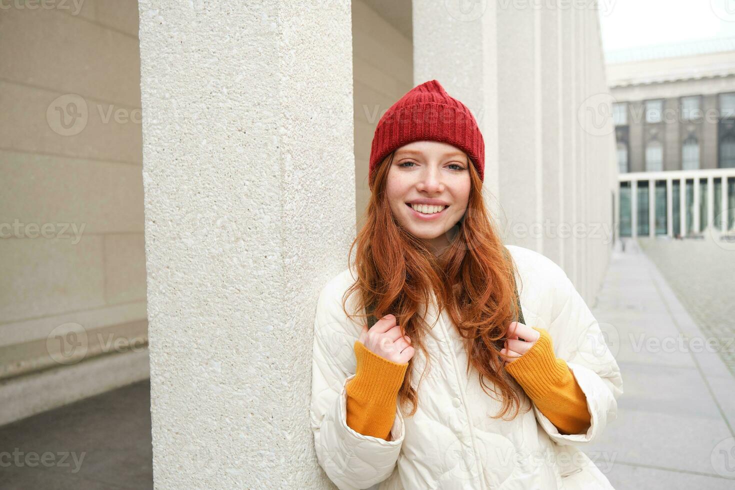 Happy redhead girl, tourist going around town, exploring sighsteeing places in city, backpacking around europe, enjoys travelling photo