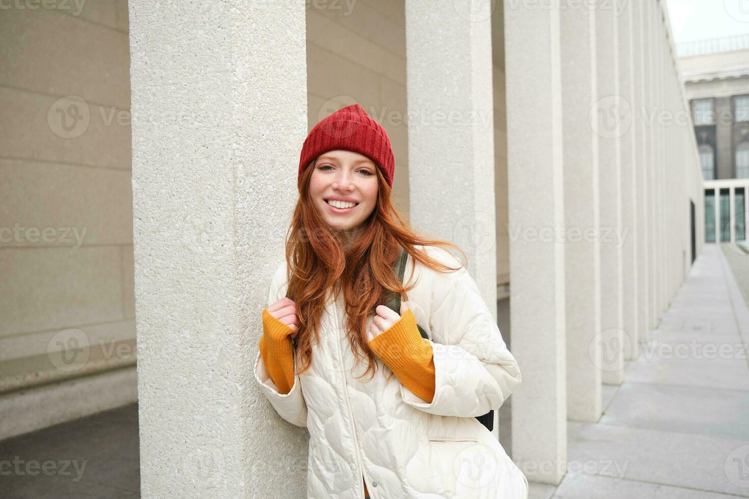 Happy redhead girl, tourist going around town, exploring sighsteeing places in city, backpacking around europe, enjoys travelling photo