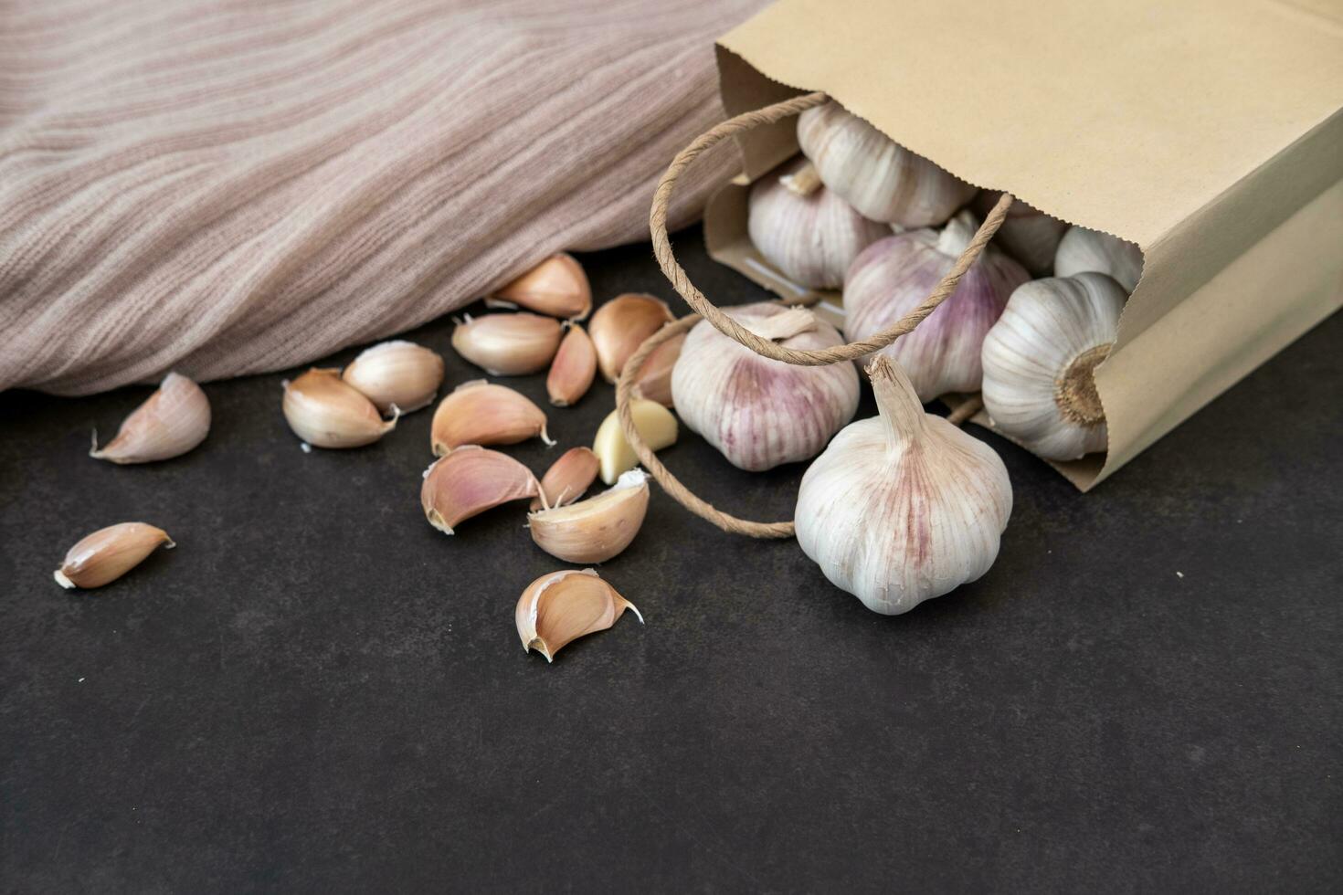 Big and small heads of garlic on a black background. photo