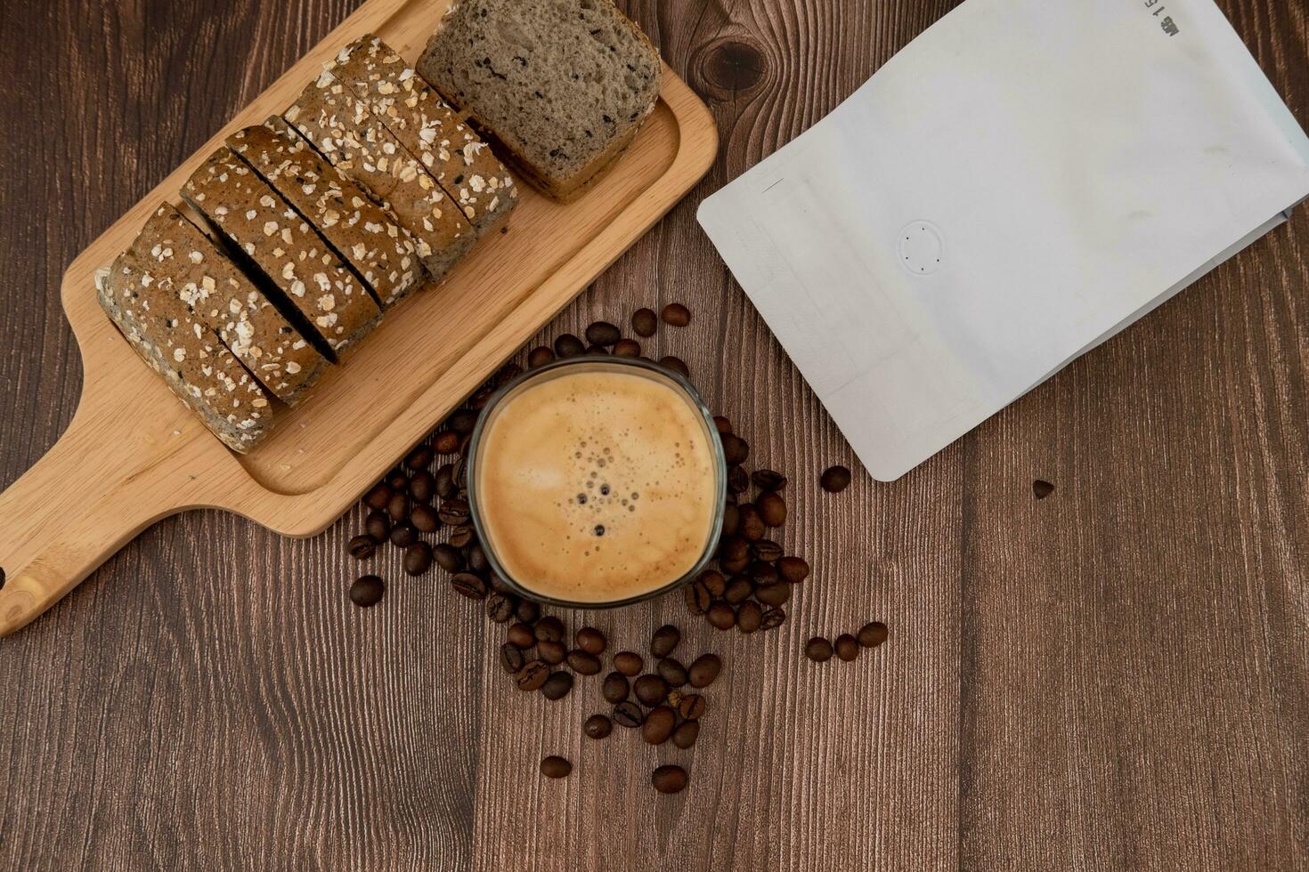 Top view, coffee cup, coffee flavored bread slices with coffee beans around photo