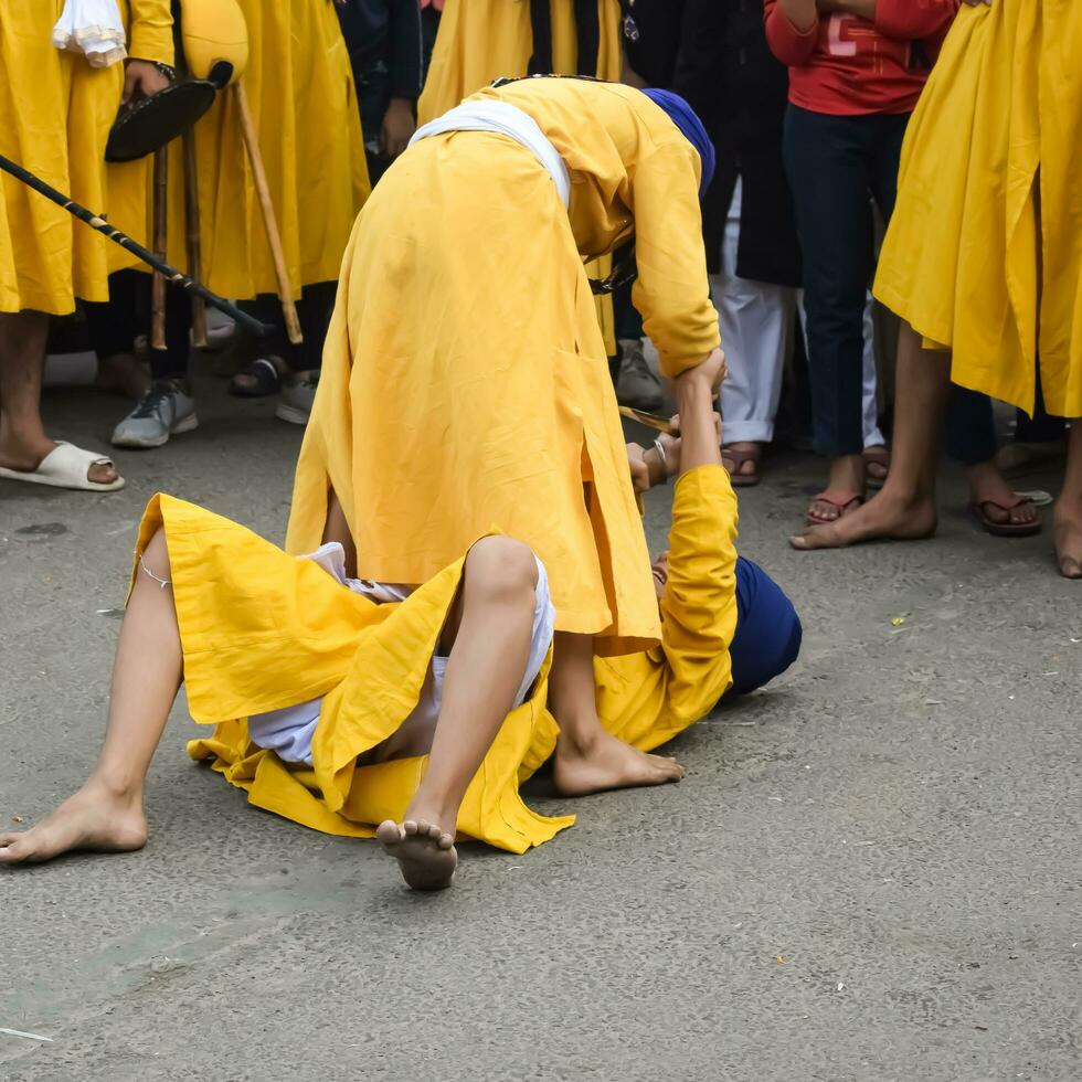 Delhi, India, October 2, 2023 - Sikhs display gatka and martial arts during annual Nagar Kirtan, Traditional, procession on account of birthday of Guru Nanak Dev ji, Nagar Kirtan in East Delhi area photo