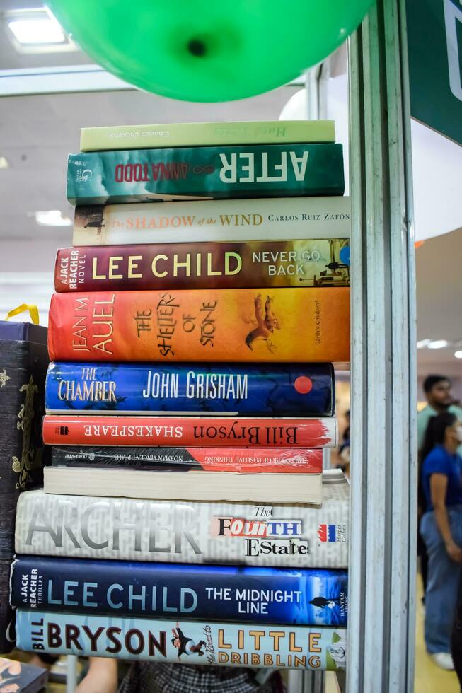 New Delhi, India, September 09 2023 - Variety of Books on shelf inside a book-stall at Delhi International Book Fair, Selection of books on display in Annual Book Fair. photo