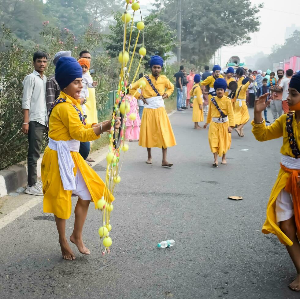 Delhi, India, October 2, 2023 - Sikhs display gatka and martial arts during annual Nagar Kirtan, Traditional, procession on account of birthday of Guru Nanak Dev ji, Nagar Kirtan in East Delhi area photo