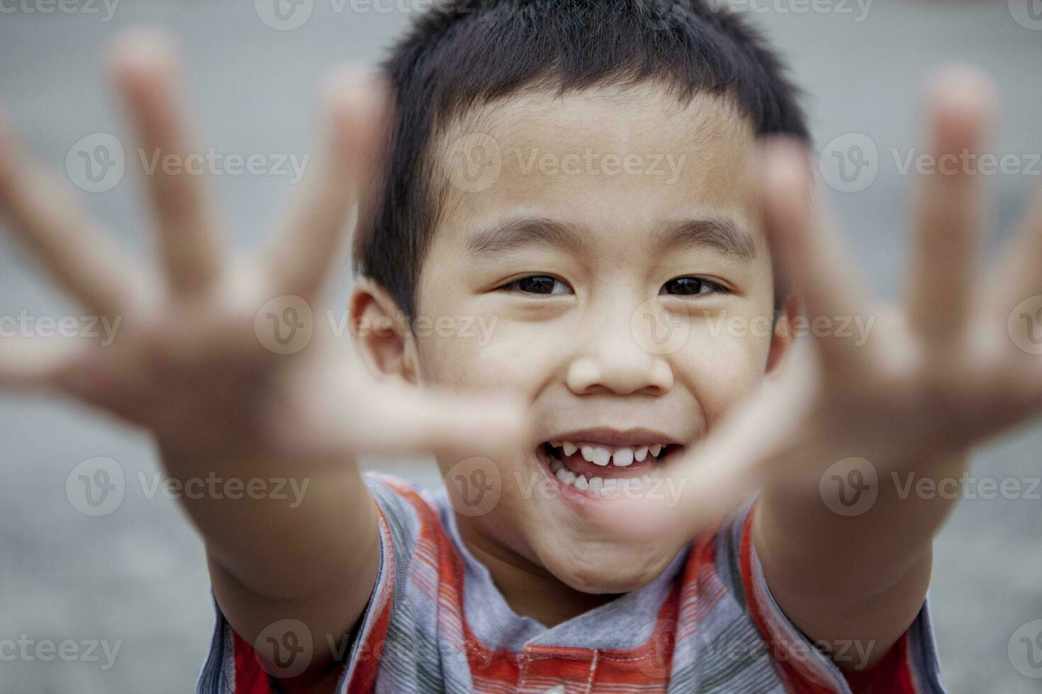 headshot of cheerful asian children looking with eye contact to camera photo