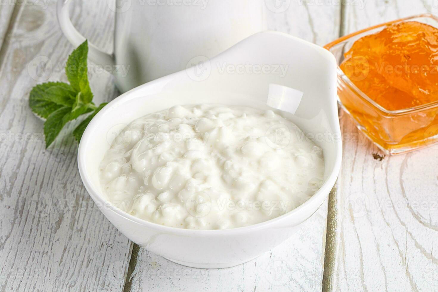Grain curd with cream and jam photo