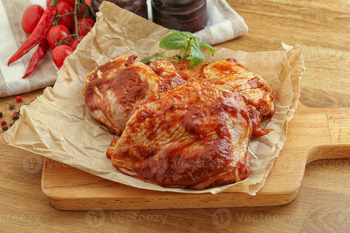 Marinated chicken leg in tomato sauce photo