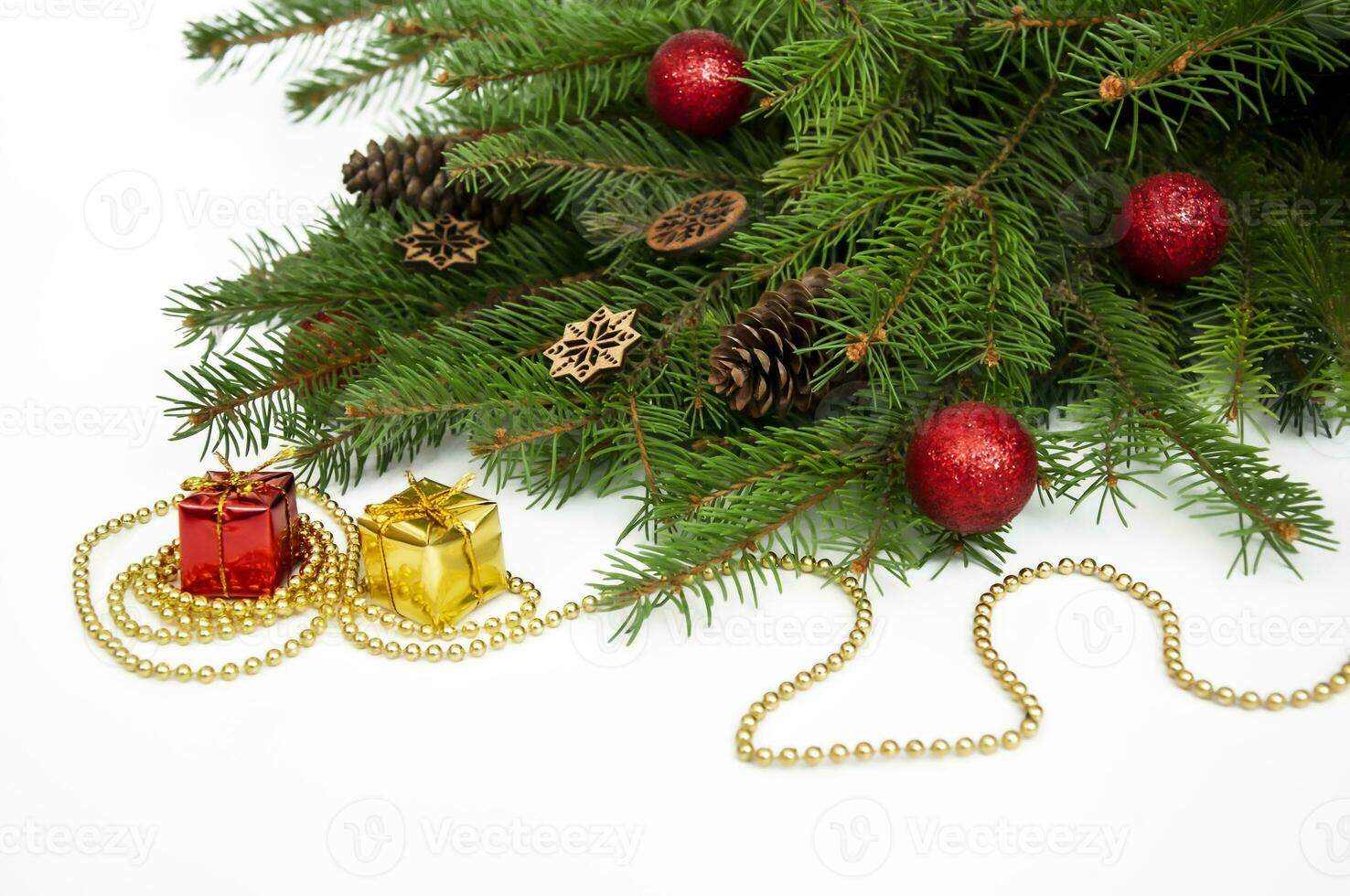 Branches of a Christmas tree and red and yellow gift boxes and balls on a white background. Christmas background with copyspace. photo