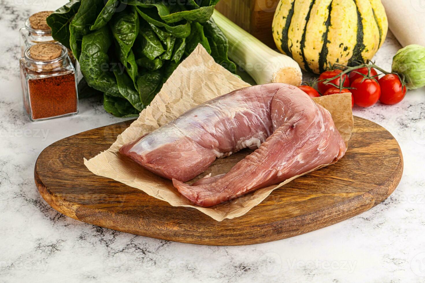 Uncooked raw pork tenderloin with spices photo