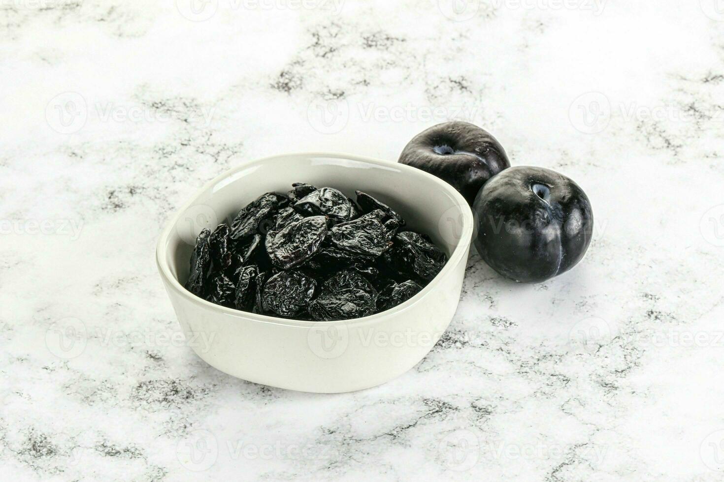 Dry prunes in thw bowl photo