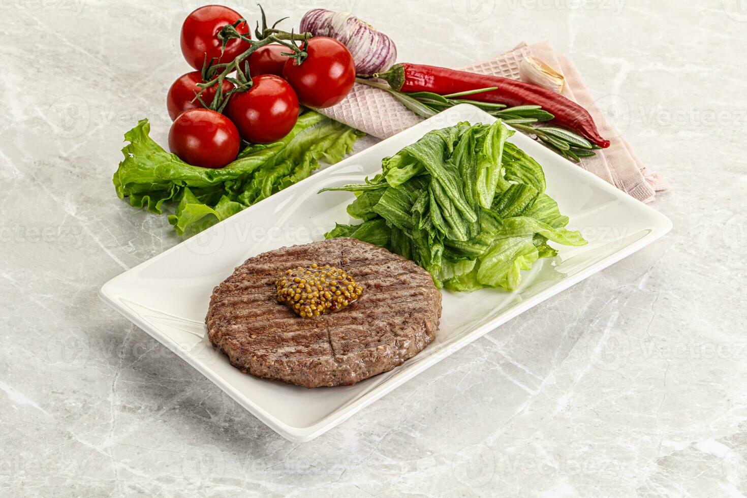 Frilled beef burger cutlet with iceberg photo