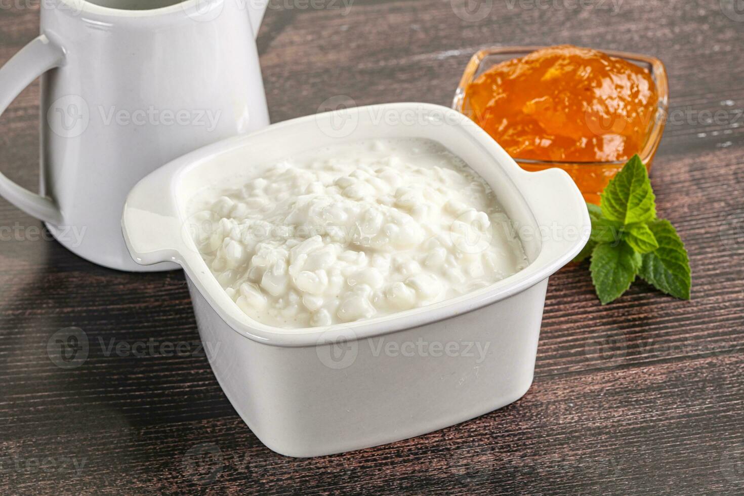 Grain curd with cream and jam photo