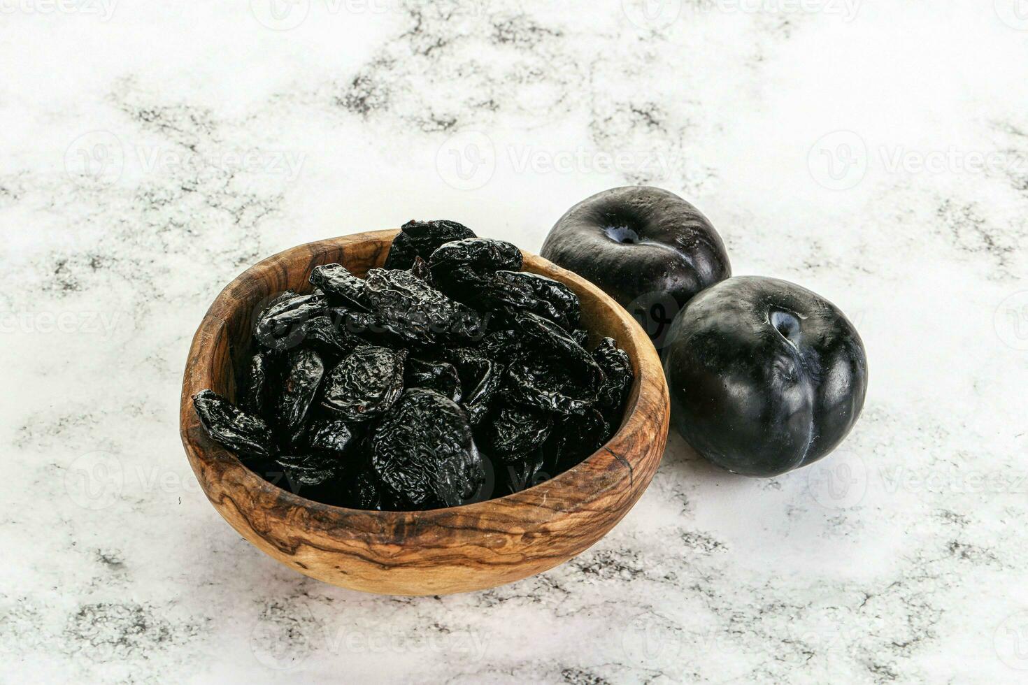 Dry prunes in thw bowl photo