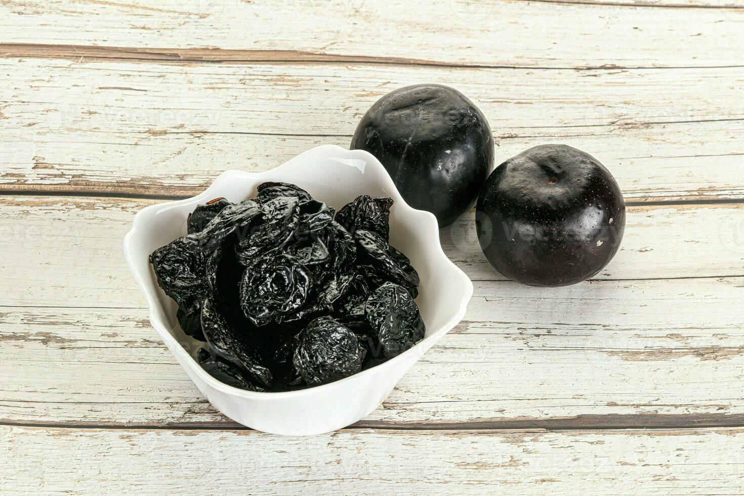 Dry prunes in thw bowl photo