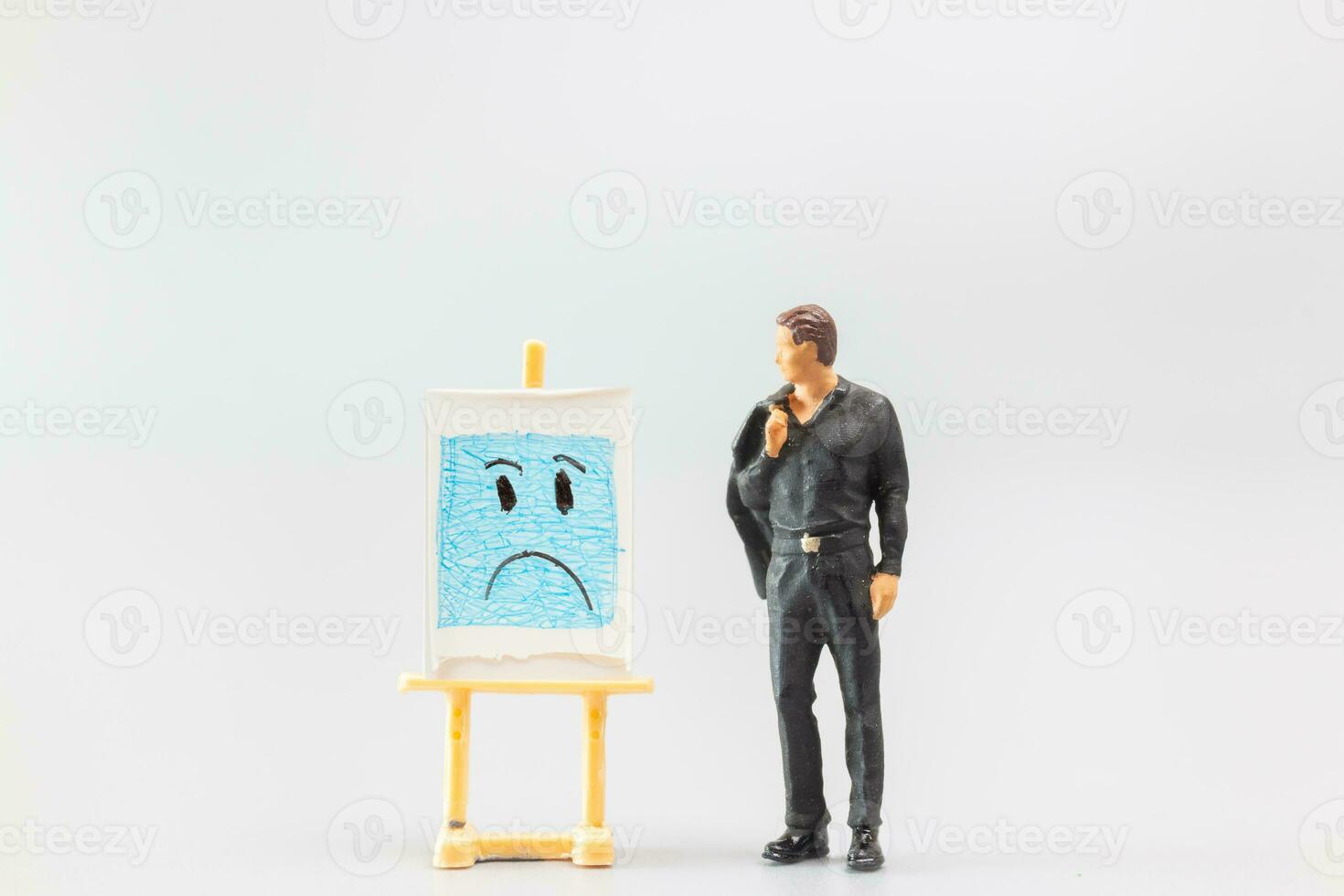 Miniature people, A dejected businessman is positioned in front of a white board, Blue monday concept photo