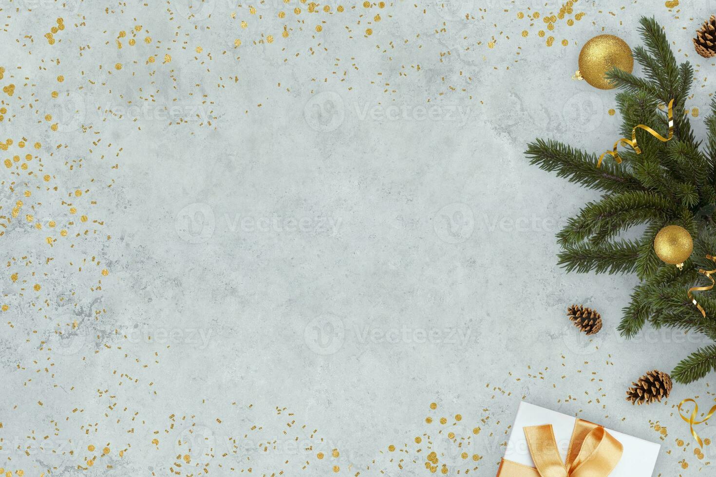 New Year grey concrete background with Christmas tree with golden ball and gifts with free copy space for text and design, concept. Christmas and New Year background card, creative idea photo