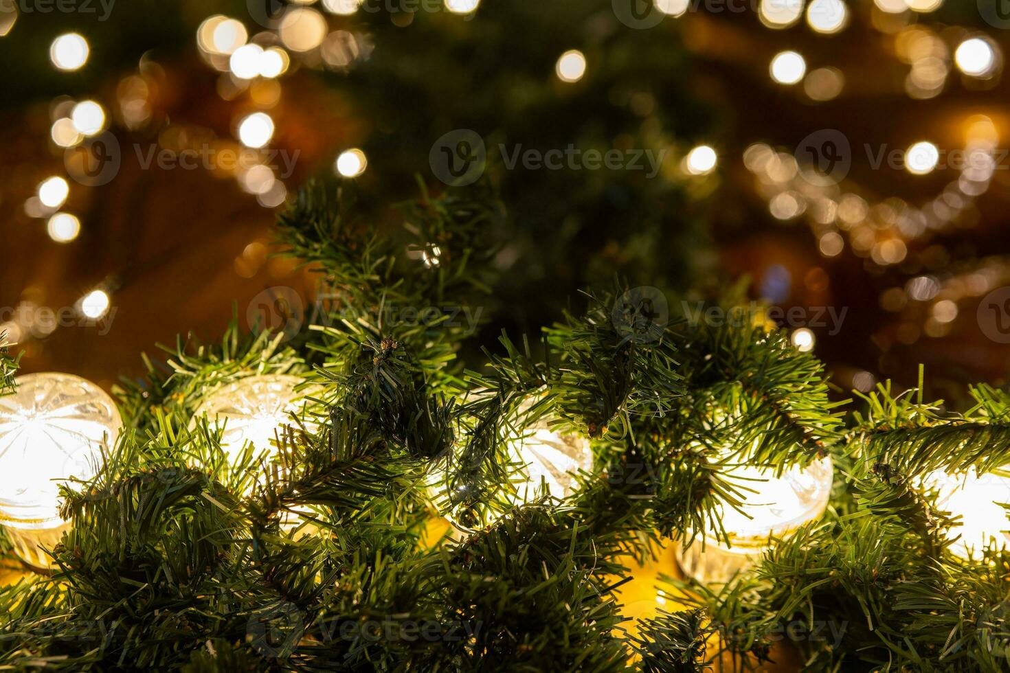 string of lights between artificial pine needles photo