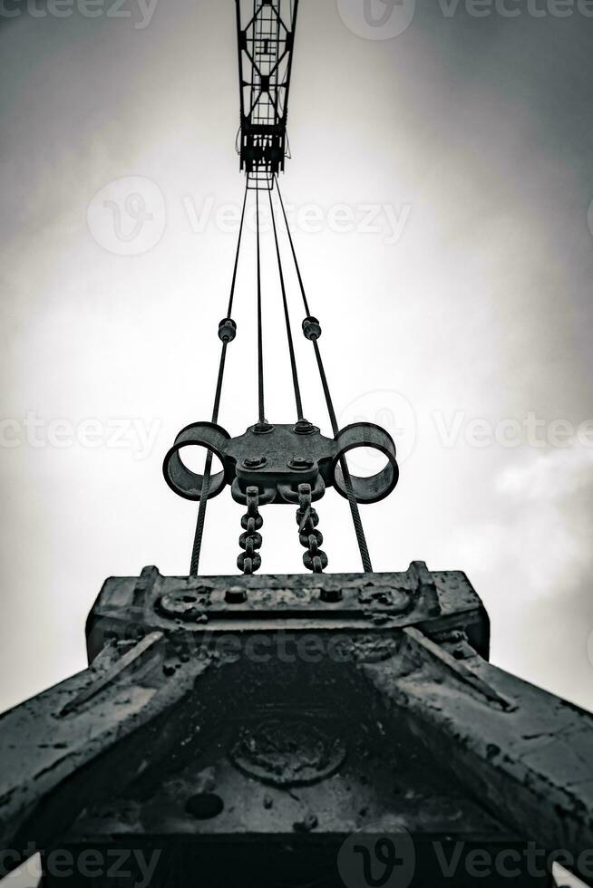 an industrial crane at the harbor with a view from below photo