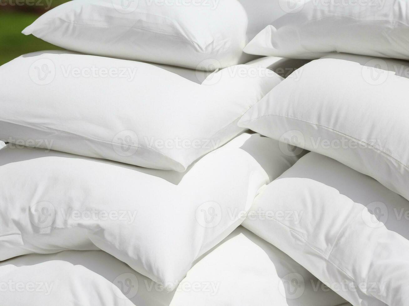 pile of pillows on white bed photo