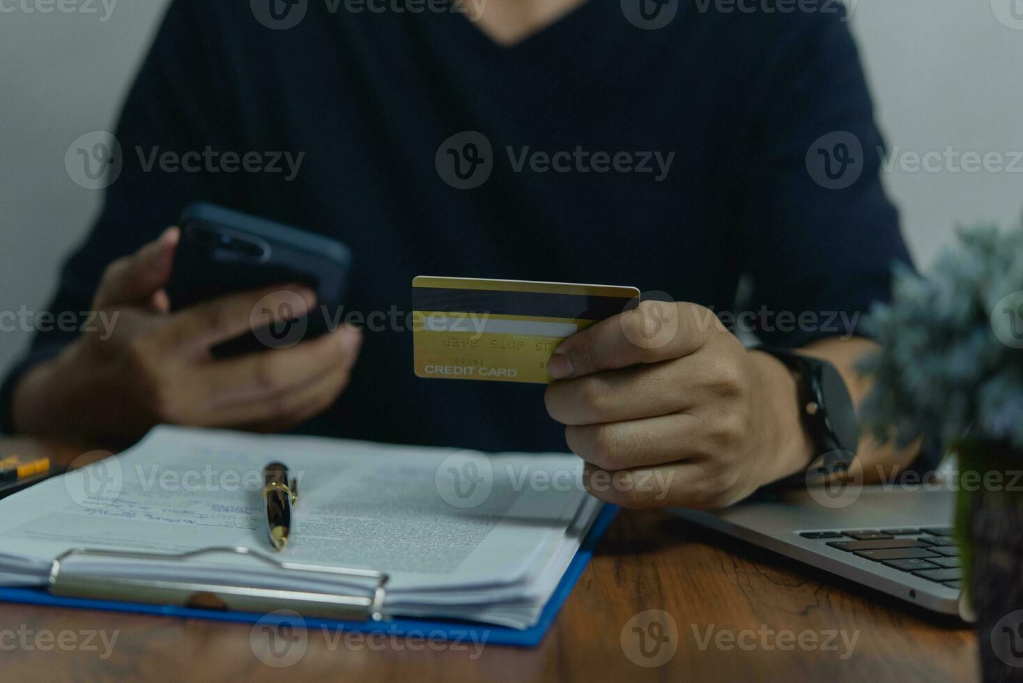 Man holding credit card and mobile phone payment financial internet banking online. Business e-commerce online shopping. making transaction photo