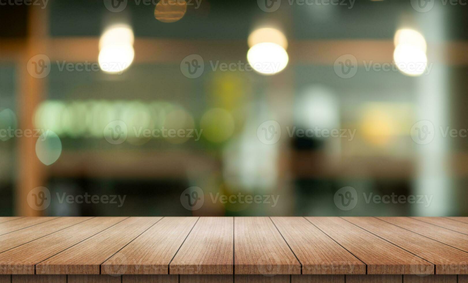 Empty wooden table top with lights bokeh on blur restaurant background. photo