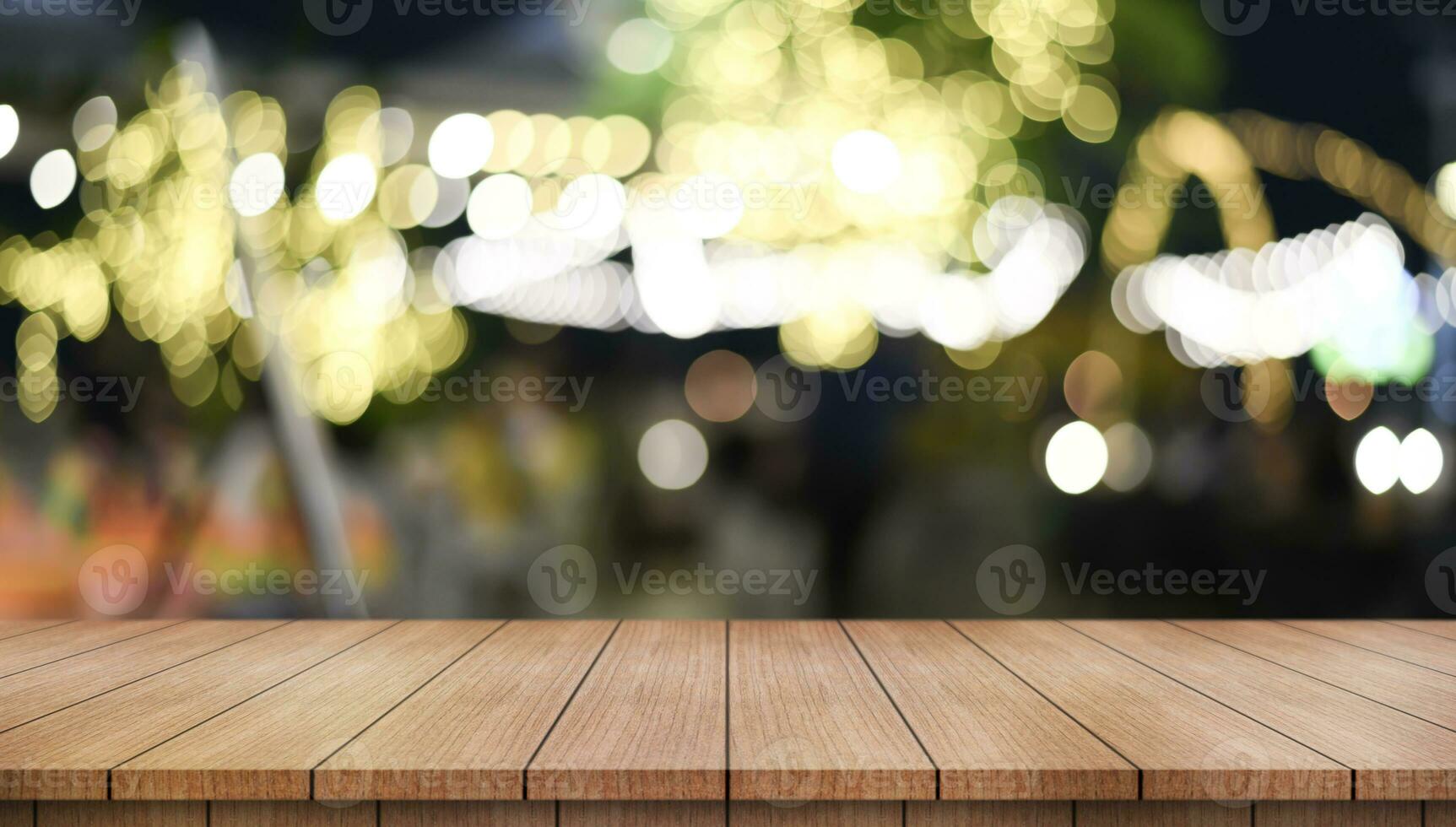 Empty wooden table top with lights bokeh on blur restaurant background. photo