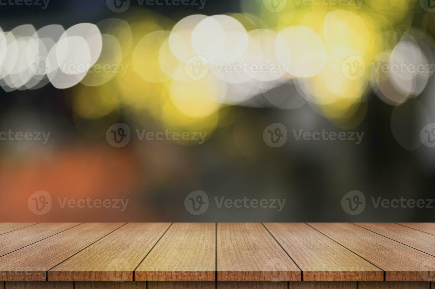 Empty wooden table top with lights bokeh on blur restaurant background. photo