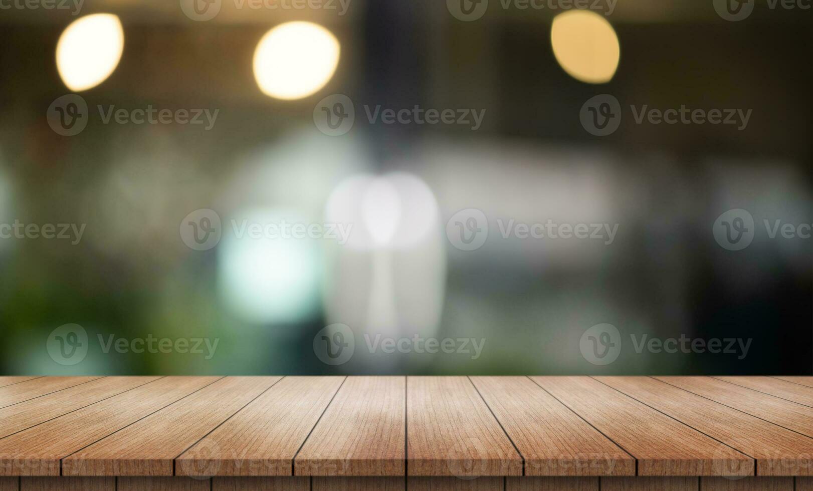 Empty wooden table top with lights bokeh on blur restaurant background. photo