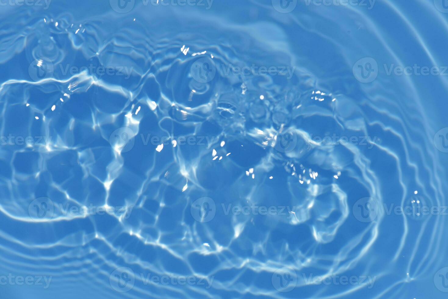 Bluewater bubbles on the surface ripples. Defocus blurred transparent white-black colored clear calm water surface texture with splash and bubbles. Water waves with shining pattern texture background. photo