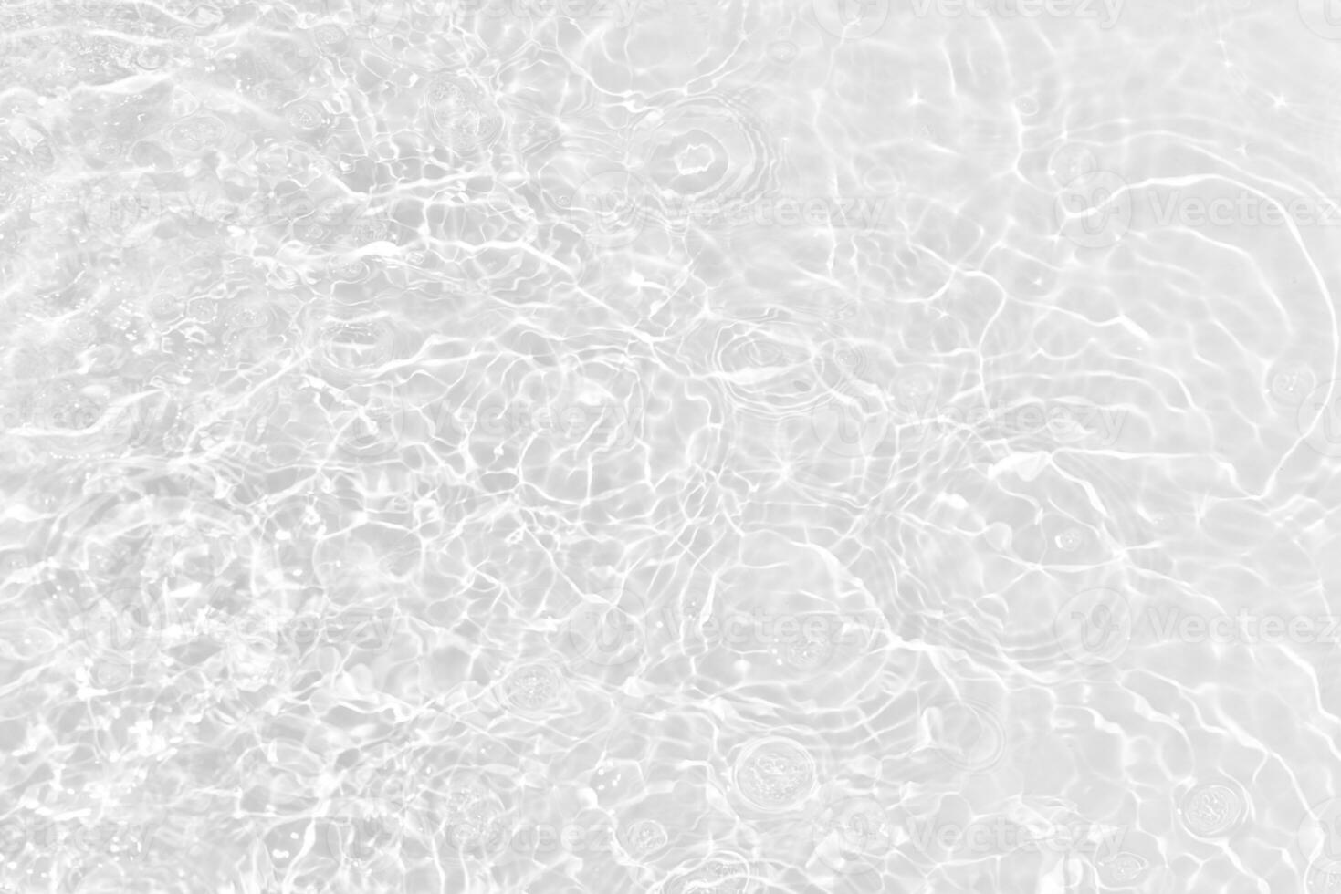 White water with ripples on the surface. Defocus blurred transparent white colored clear calm water surface texture with splashes and bubbles. Water waves with shining pattern texture background. photo