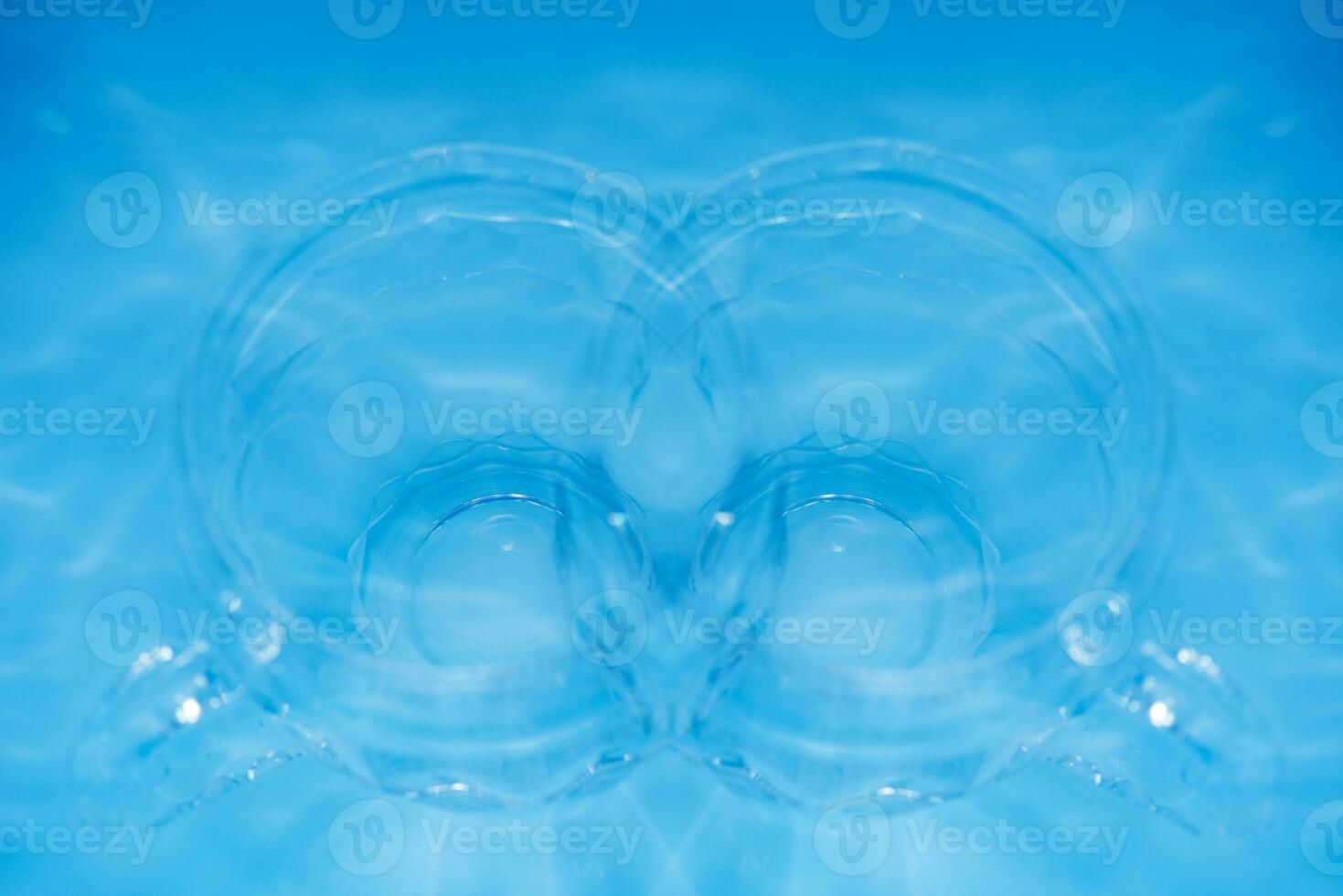 Bluewater bubbles on the surface ripples. Defocus blurred transparent white-black colored clear calm water surface texture with splash and bubbles. Water waves with shining pattern texture background. photo