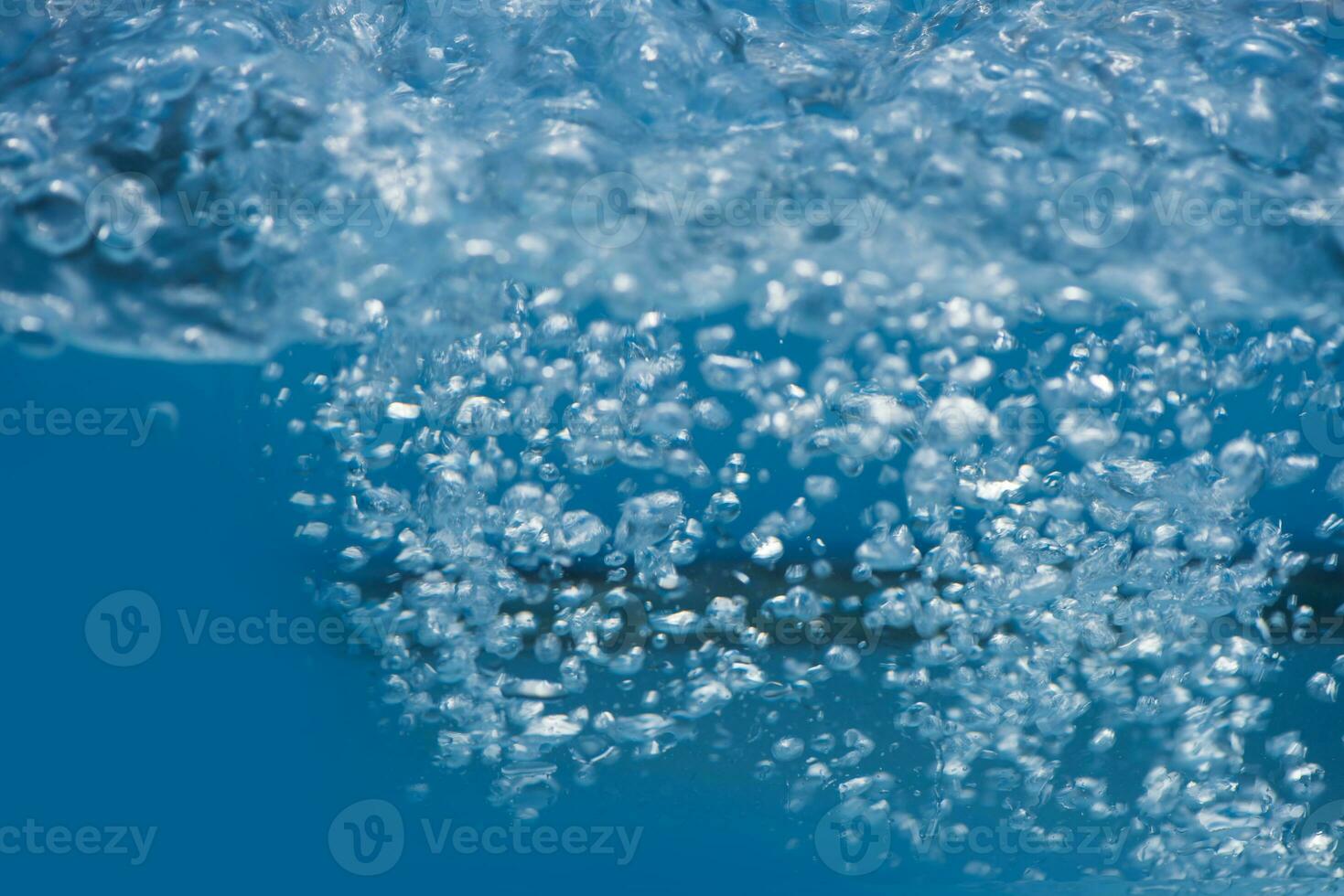 Bluewater bubbles on the surface ripples. Defocus blurred transparent white-black colored clear calm water surface texture with splash and bubbles. Water waves with shining pattern texture background. photo