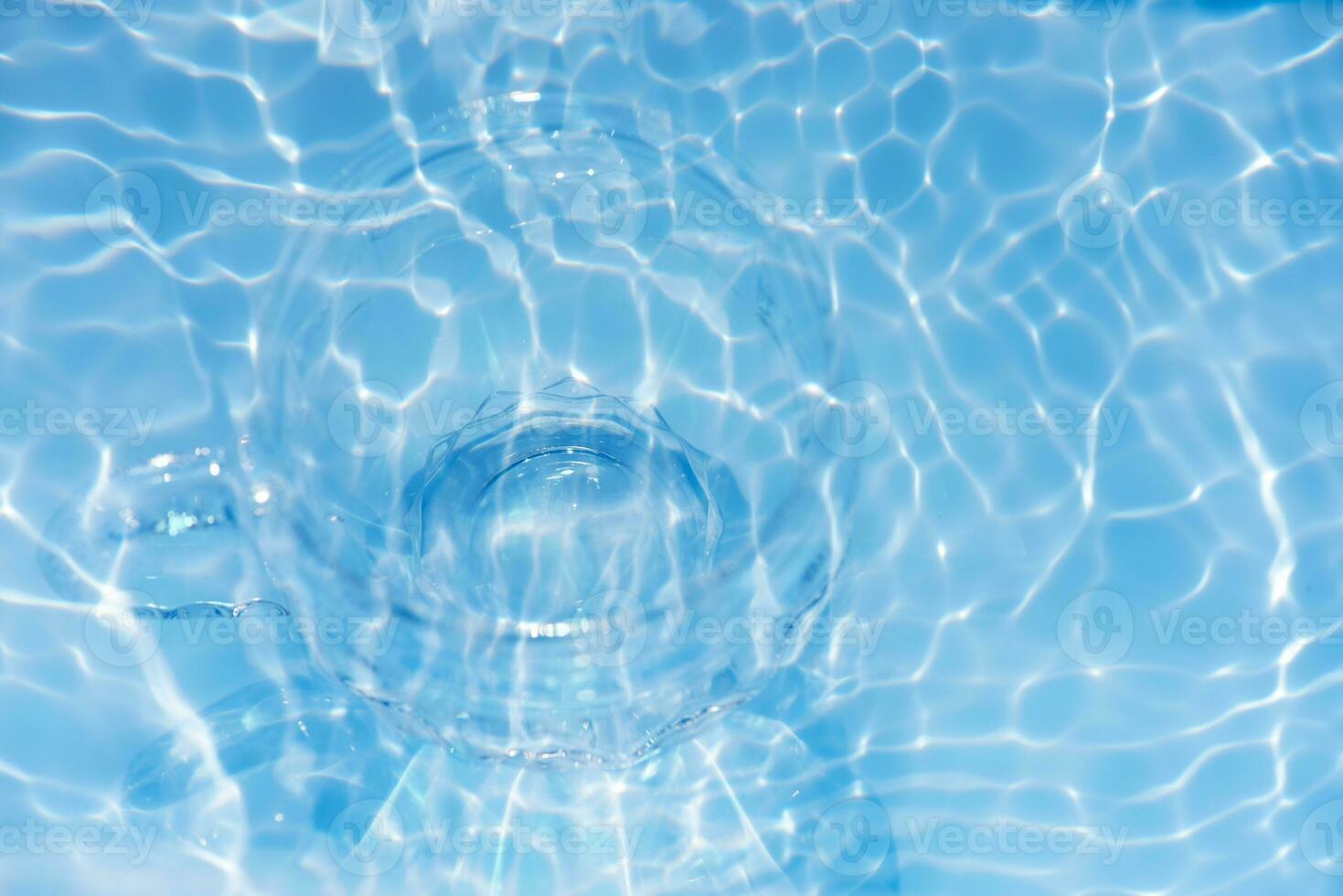 Bluewater bubbles on the surface ripples. Defocus blurred transparent white-black colored clear calm water surface texture with splash and bubbles. Water waves with shining pattern texture background. photo