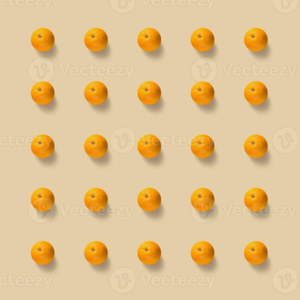 Fruit pattern of fresh oranges on yellow background. Pop art design, creative summer concept. photo
