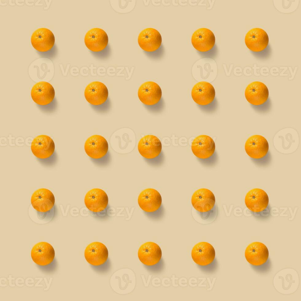 Fruit pattern of fresh oranges on yellow background. Pop art design, creative summer concept. photo