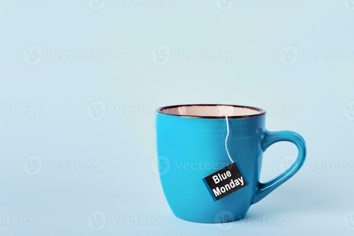 Tea bag with Blue Monday text in blue mug on blue background. Most depressed day of the year concept photo