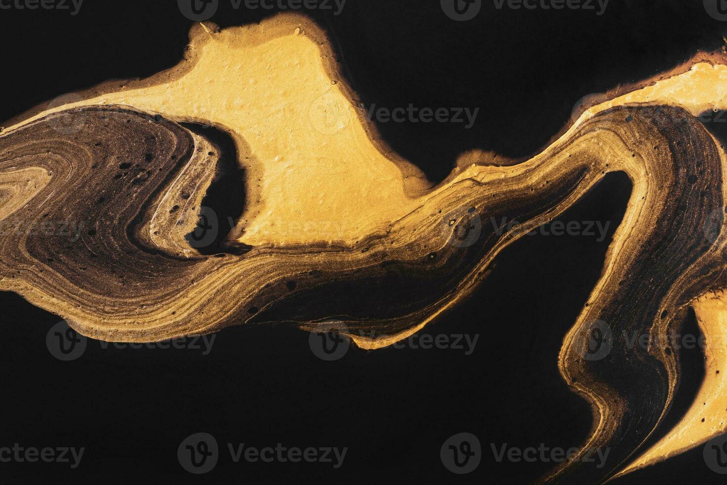 Golden wave zigzag on black. Abstract liquid marble background or texture. Acrylic Fluid Art photo