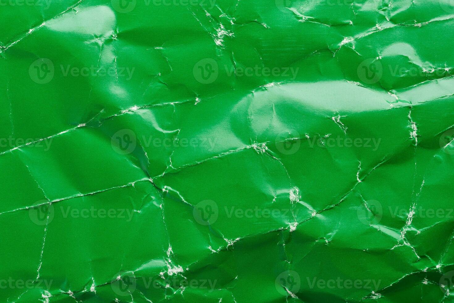 Green crumpled paper background with folds texture photo