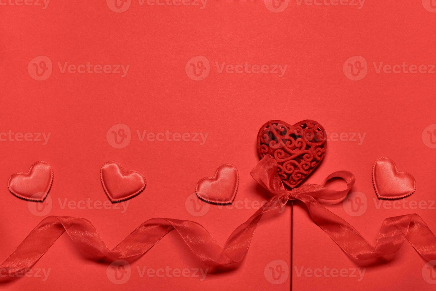 Valentine's day blank greeting card with openwork valentine heart with nylon ribbon. Red monochrome romantic background photo