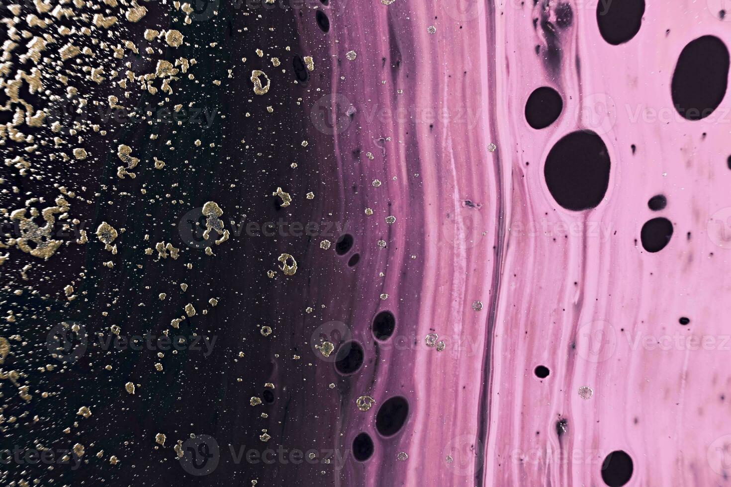 Fluid Art. Golden metallic particles and pink waves. Marble effect background or texture photo