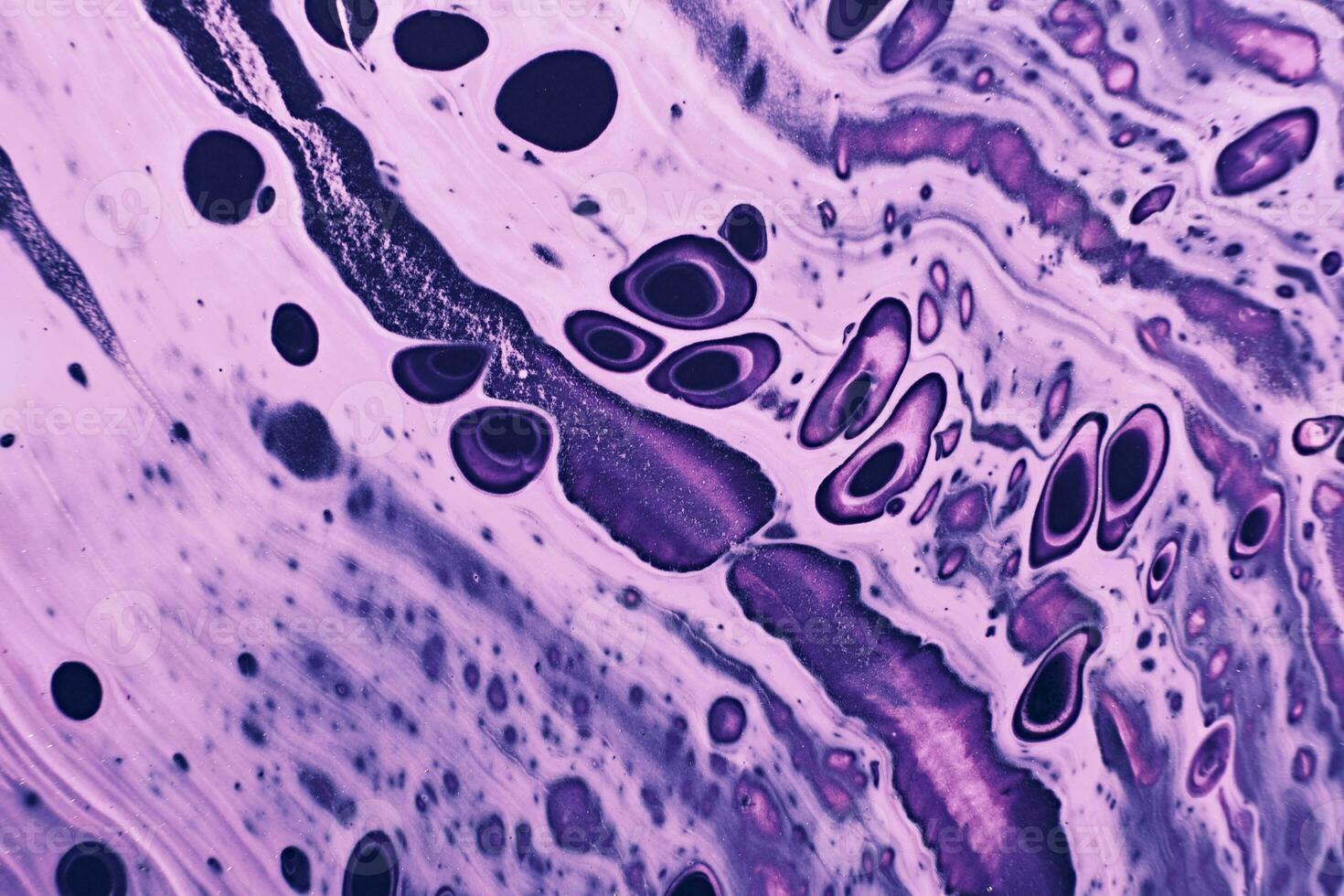 Fluid Art. Pink and purple abstract spots and waves. Marble effect background or texture photo